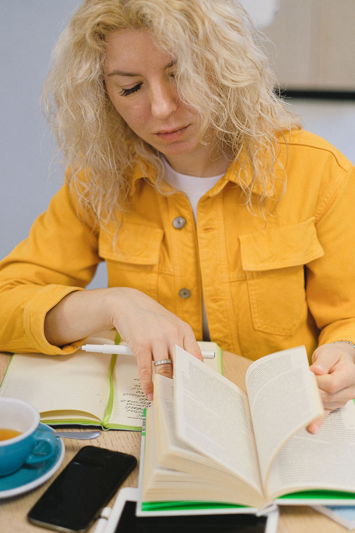 Adult learner comparing certification programs while taking notes