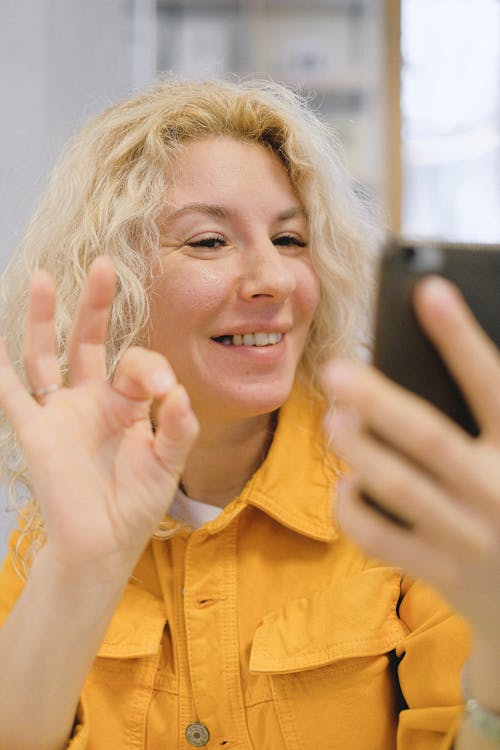 Cheerful woman having video call on smartphone