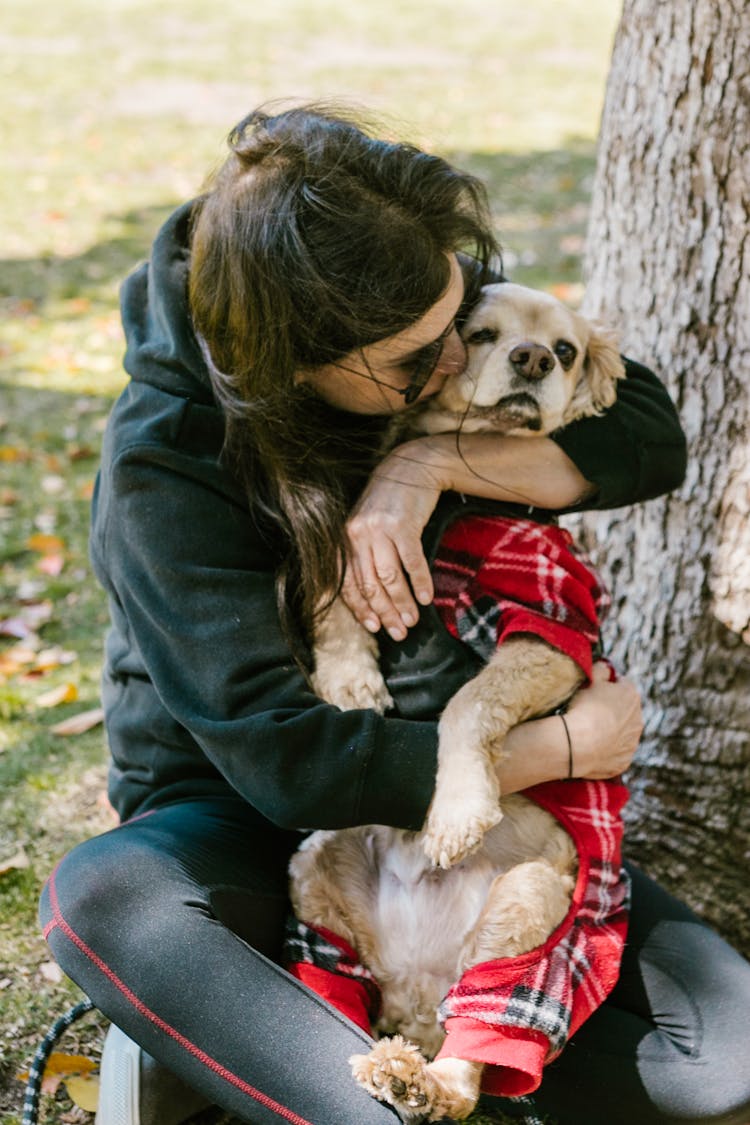 Woman Kissing A Dog