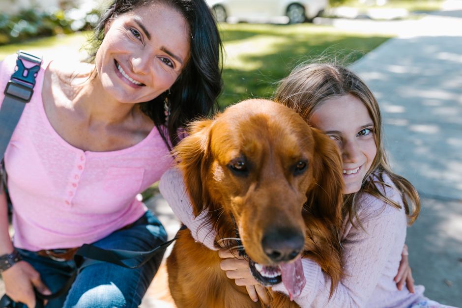 family hug suburban driveway