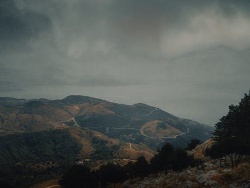 Foggy mountainous valley with roads