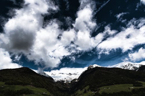 Gökyüzünün Altındaki Dağların Yakınında Fotoğraf Yeşil Arazi