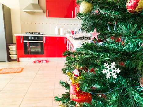 Christmas tree with decorations in a modern kitchen, capturing festive holiday vibes indoors.