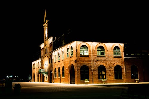 Brown Brick Building With Lights during Night Time