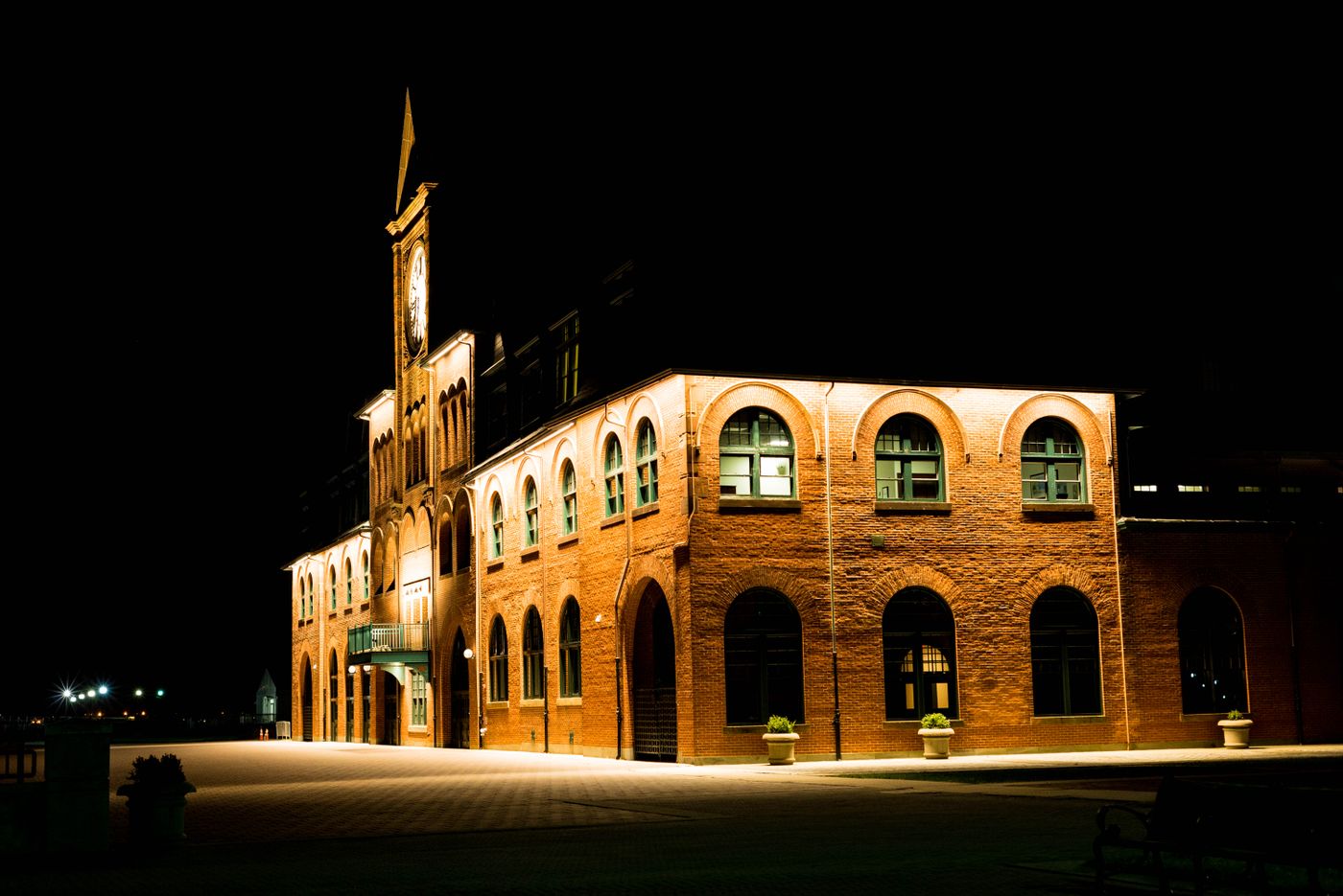 Brick building exterior lit with warm light at night