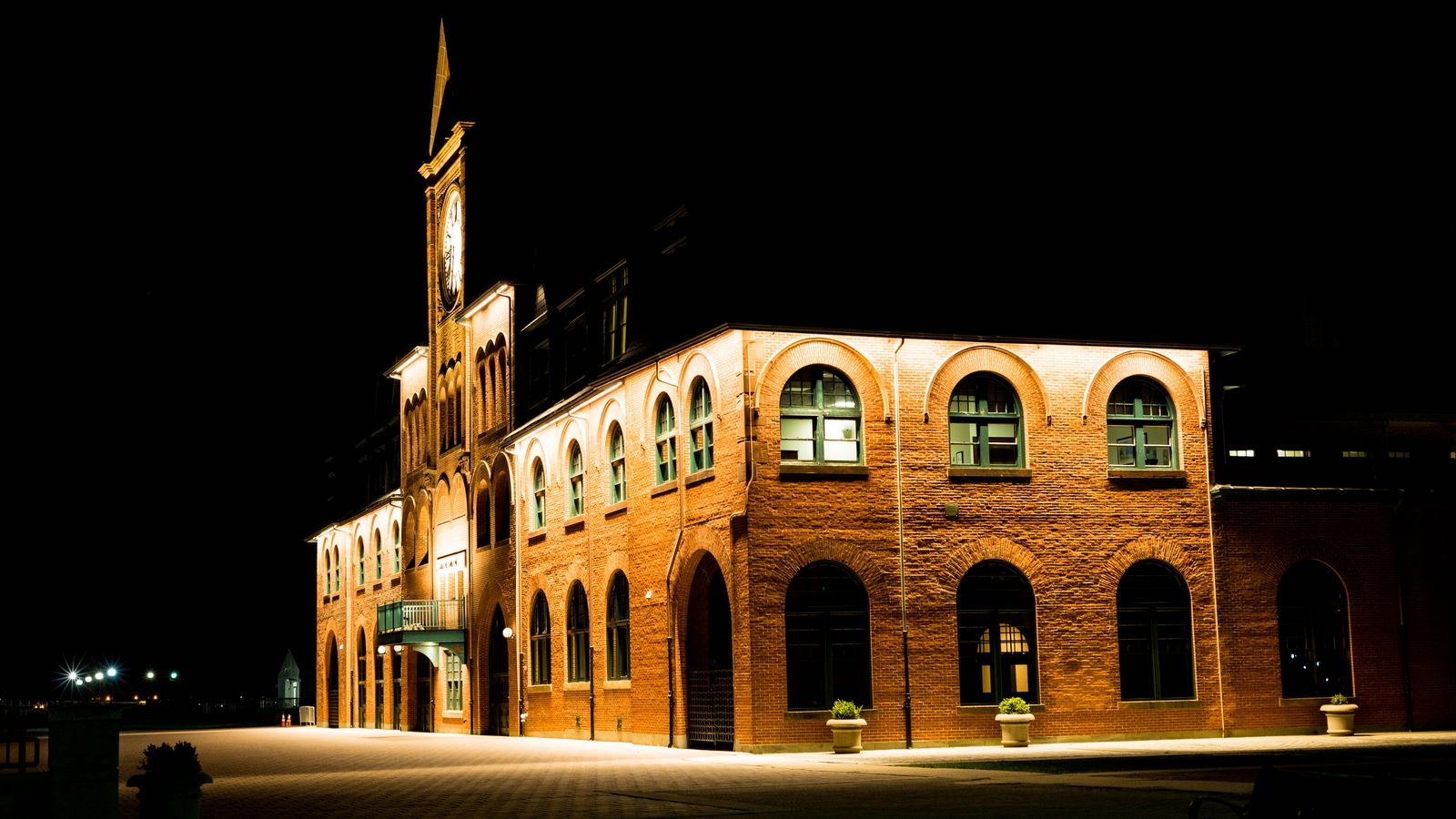 A beautiful brick building with arched windows illuminated at night in Jackson Township, New Jersey.