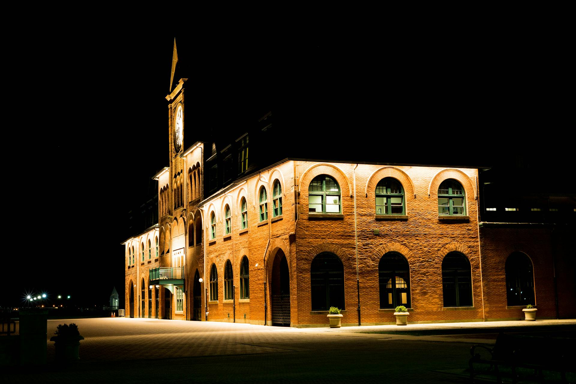 A beautiful brick building with arched windows illuminated at night in Jackson Township, New Jersey.