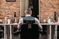 Man in White Dress Shirt Sitting on Black Chair