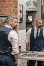 Man in Black Vest Standing Beside Man in Black Vest