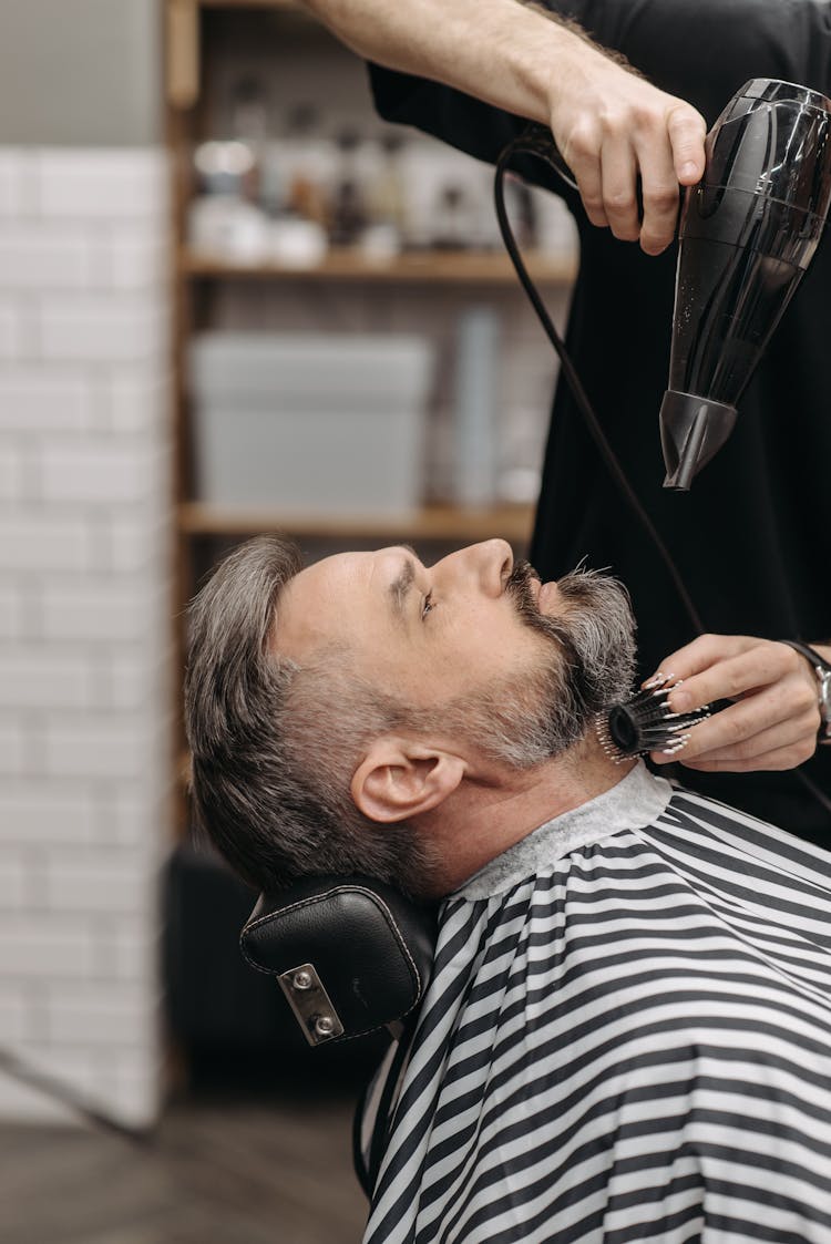 A Man Getting A Blow Dry At A Barber Shop