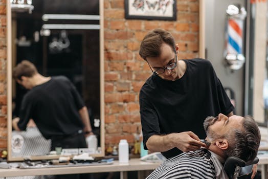Close-up of a barber giving a beard trim at a stylish barbershop.