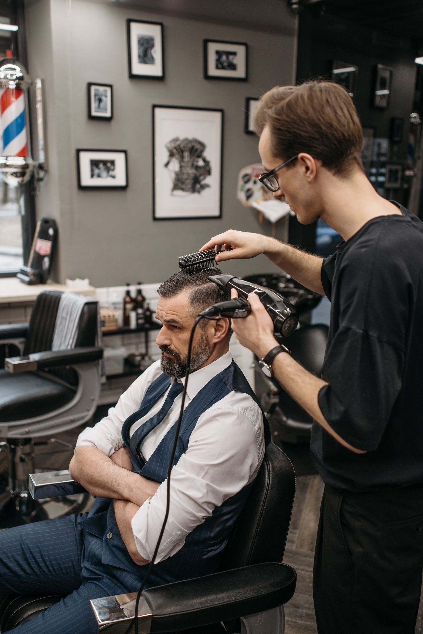 Stylist blow-drying texture into a modern cut