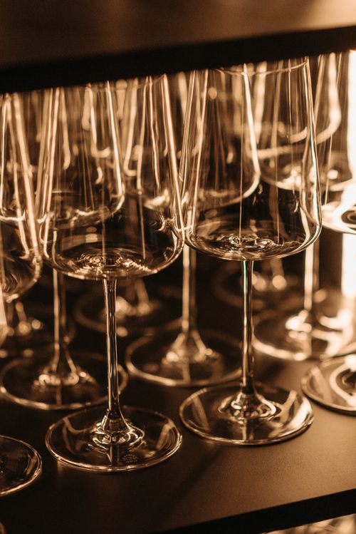 Free A close-up view of reflective wine glasses elegantly arranged on a bar counter. Stock Photo