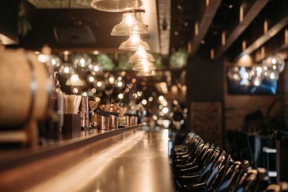 Copper bar counter under pendant lights — photo by Pavel Danilyuk on Pexels