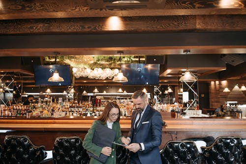 Man and Woman Having a Meeting at a Bar