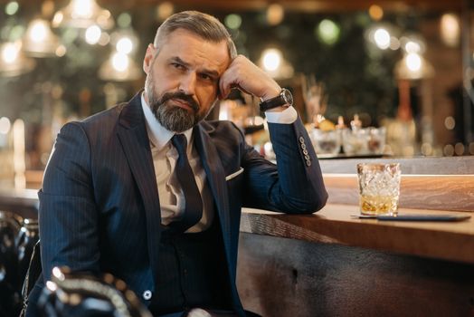 Man in a Blue Suit Waiting on a Bar Counter