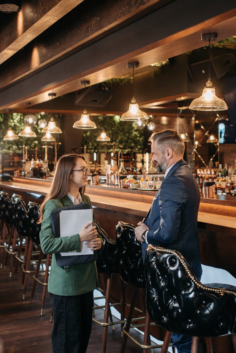 Man And A Woman Standing Near Bar Counter