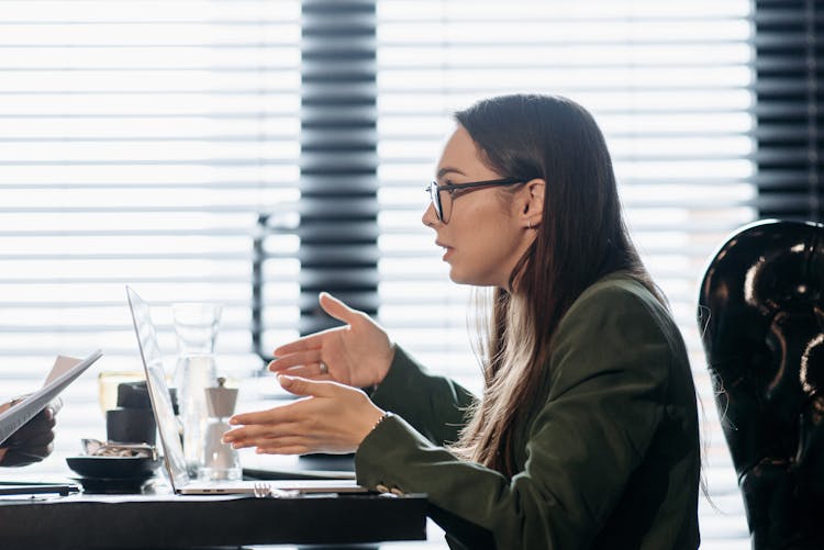 Side View Of A Woman With Eyeglasses Explaining 