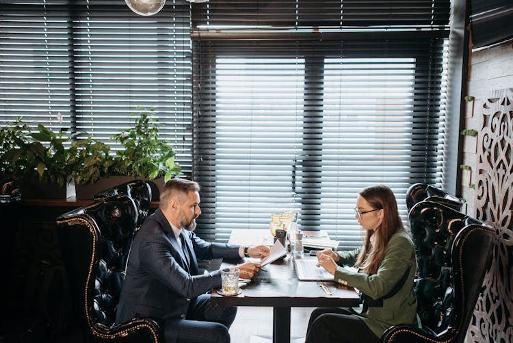 Man And A Woman Having A Business Meeting At A Restaurant