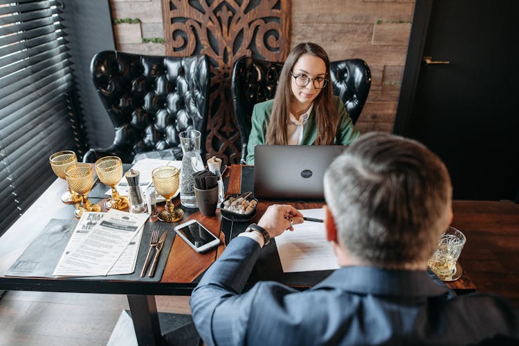 Woman With Eyeglasses Listening In A Meeting