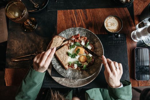 A fresh brunch scene with eggs, toast, and coffee on a rustic wooden table.
