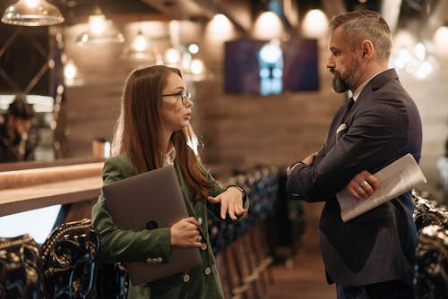 Businesspeople Standing in a Bar and Having a Discussion 