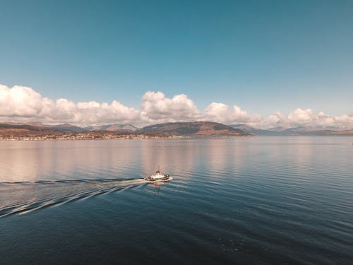 White Boat Sailing on the Sea Under the Blue Sky 