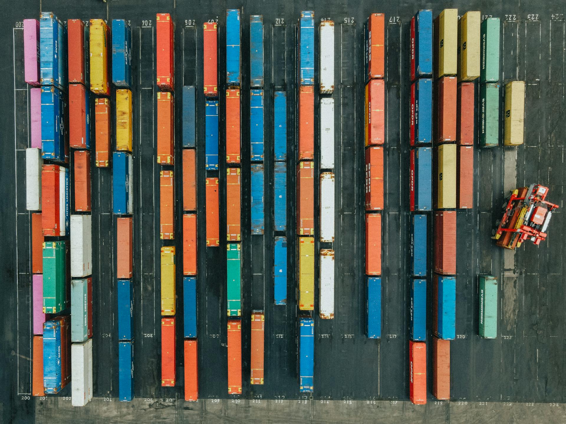 Aerial shot of colorful cargo containers in a logistics hub, Scotland.