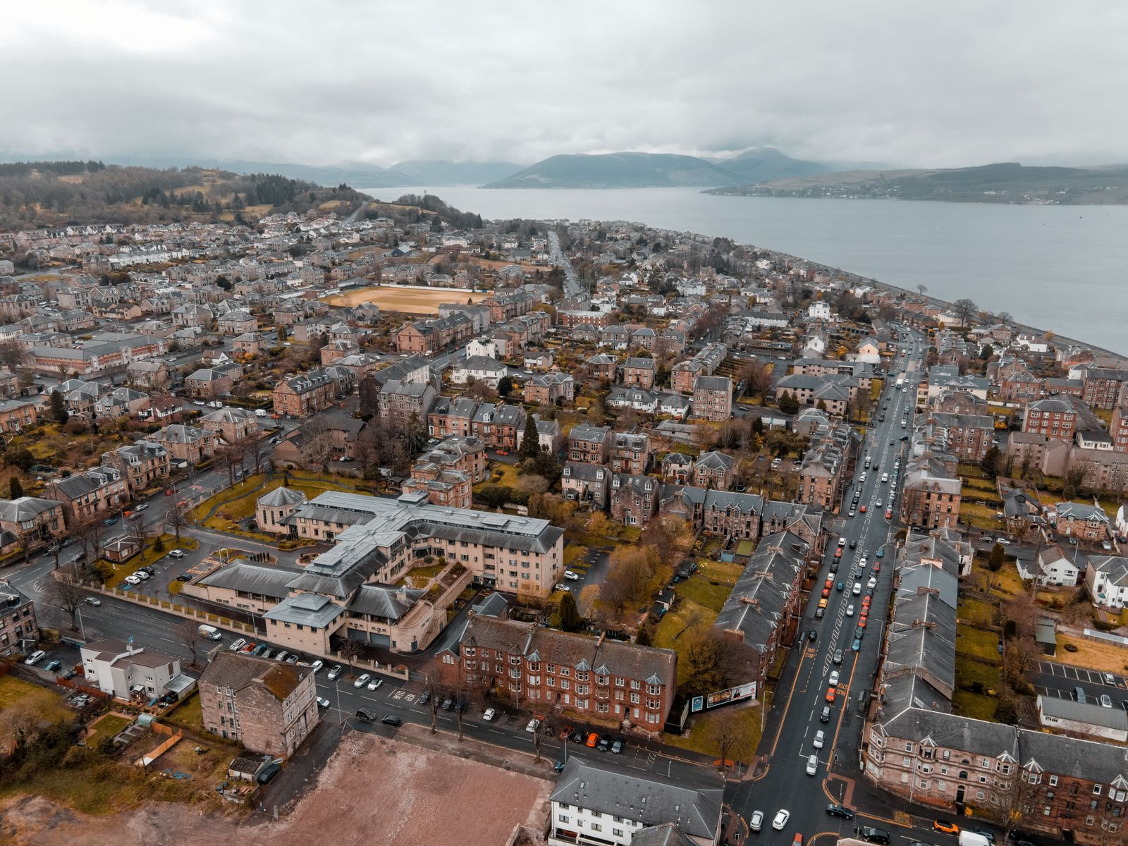 Aerial view of a coastal Scottish town, representing homes we cover in and around Forfar