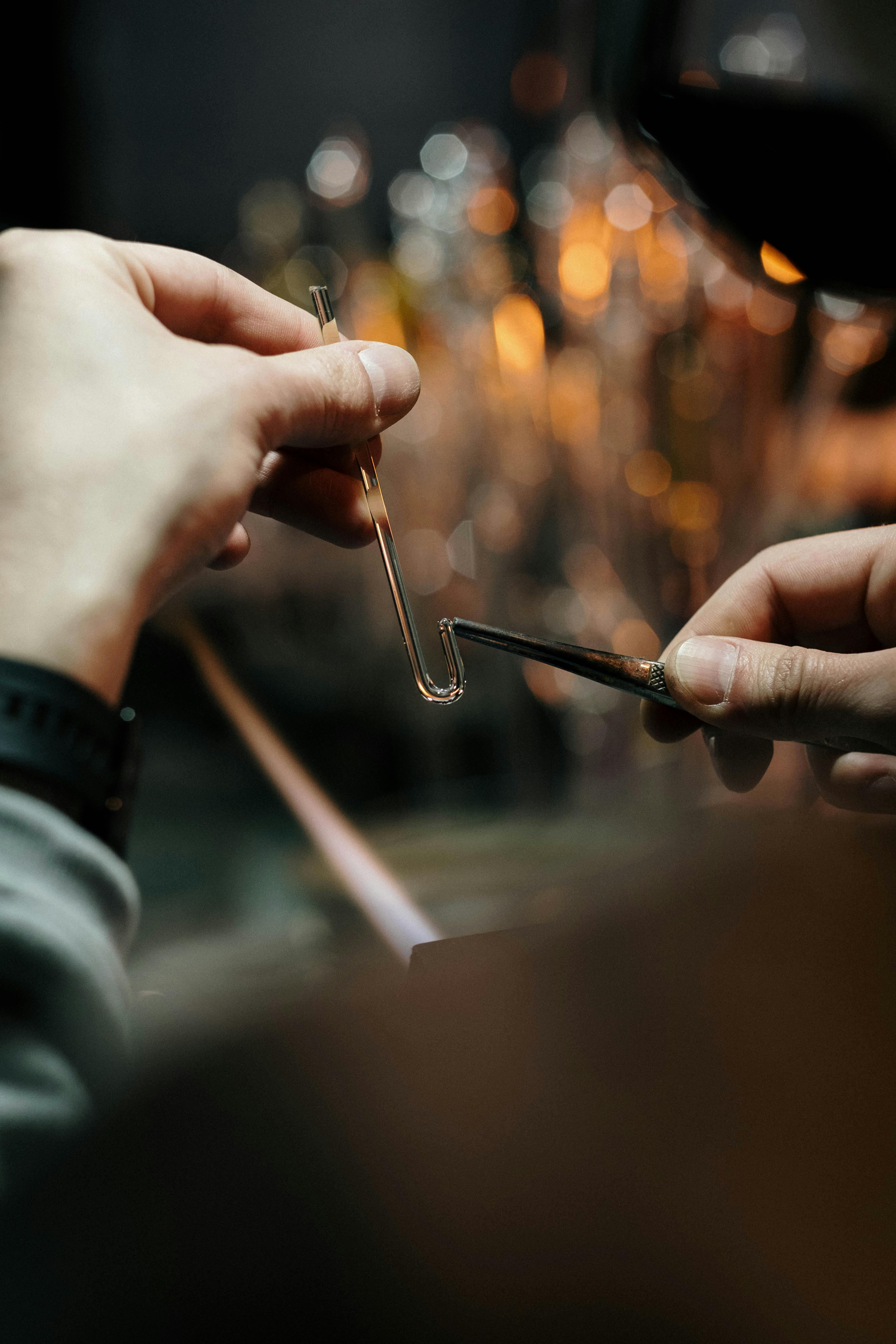 close up of man making a glass item