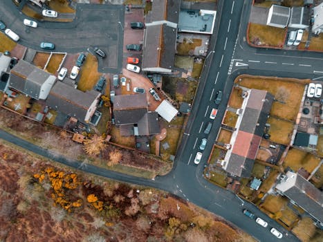 Aerial shot capturing the roofscape of houses and roads in a Scottish residential neighborhood.