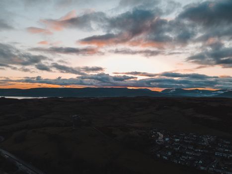 Breathtaking view of a sunset over the hills and villages in Scotland's Highlands.