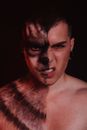 Topless Man With Brown and White Powder on His Face