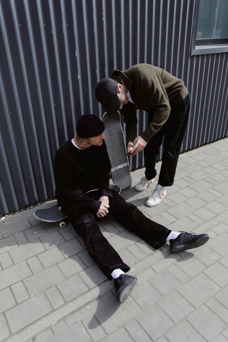 A Man Showing His Smartphone To His Friend