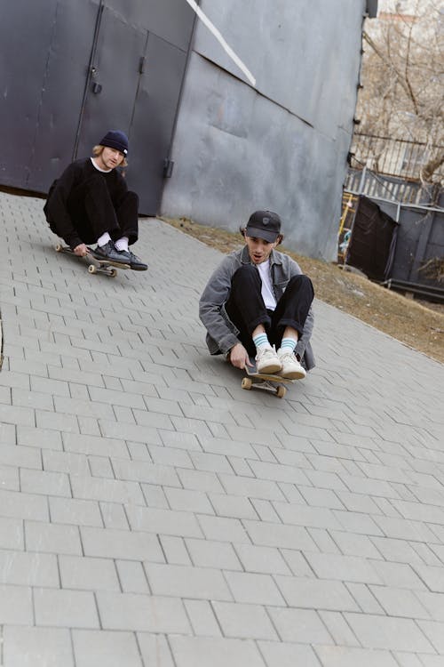 Photo of Men Riding Skaterboards