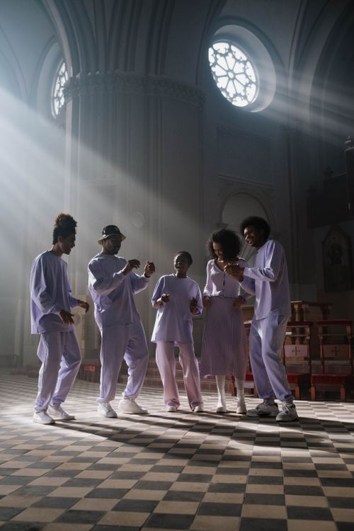 Free African American choir members singing in a sunlit church interior, creating a spiritual and uplifting atmosphere. Stock Photo
