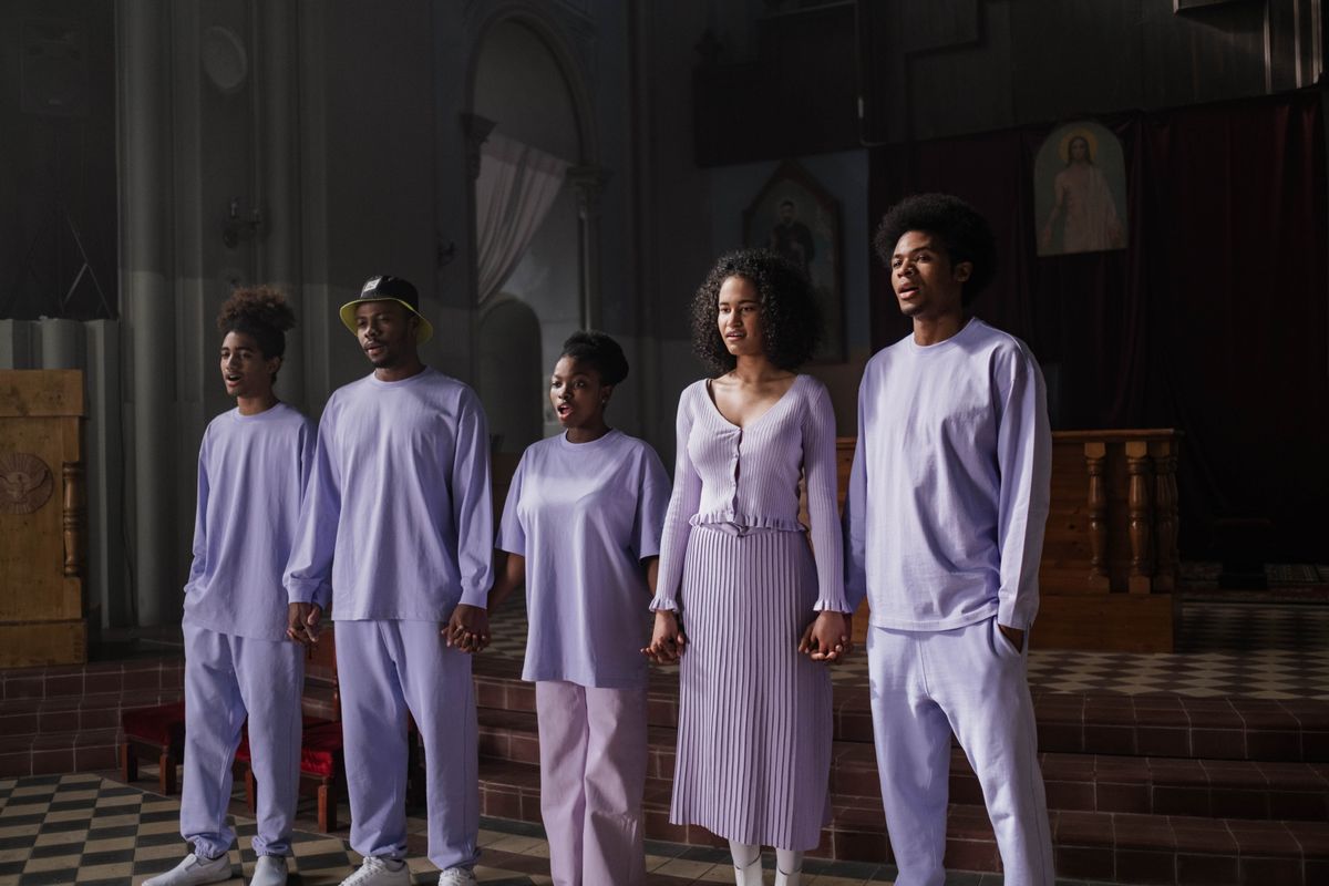 Choir members singing together in a sunlit church