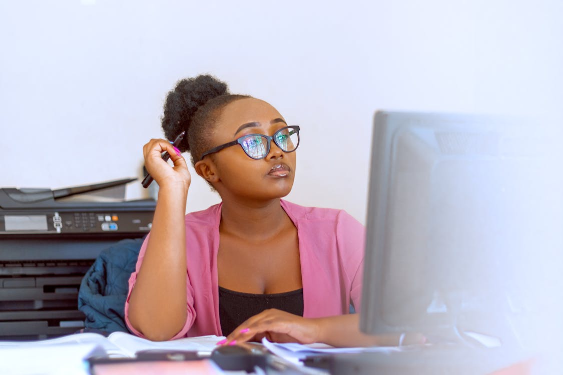 Free Photo of a Woman with Eyeglasses Working on Her Computer Stock Photo