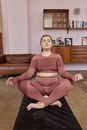 A Woman Doing Yoga Inside the House