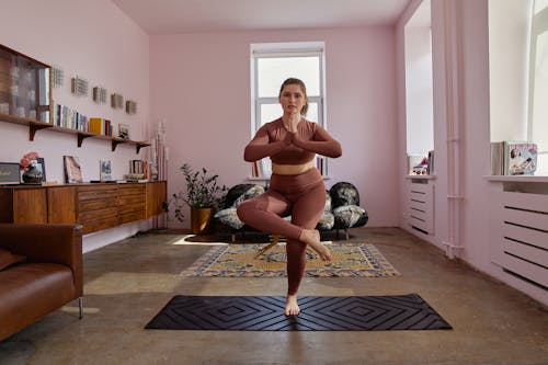 A Woman in Brown Activewear Doing Yoga
