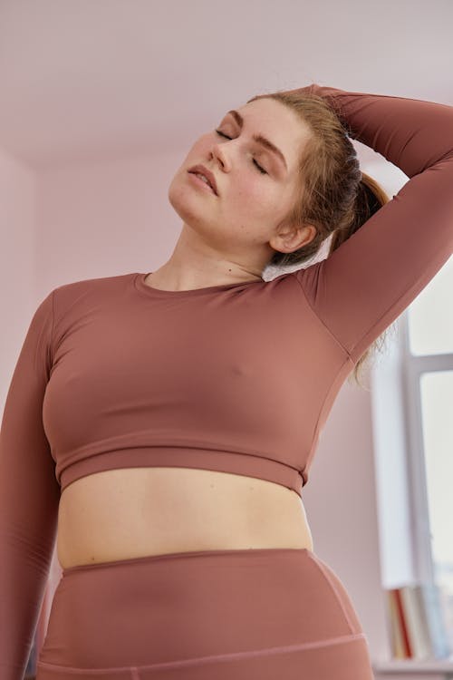 Free A Woman in Brown Activewear Stretching Stock Photo