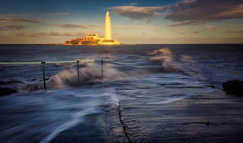 Waves and Lighthouse in Background