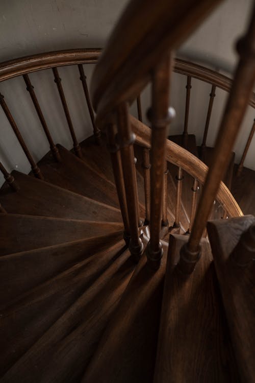 Free Brown Wooden Spiral Staircase With Brown Wooden Railings Stock Photo