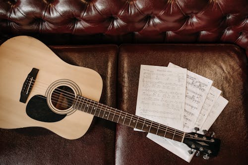 Acoustic Guitar on Leather Sofa