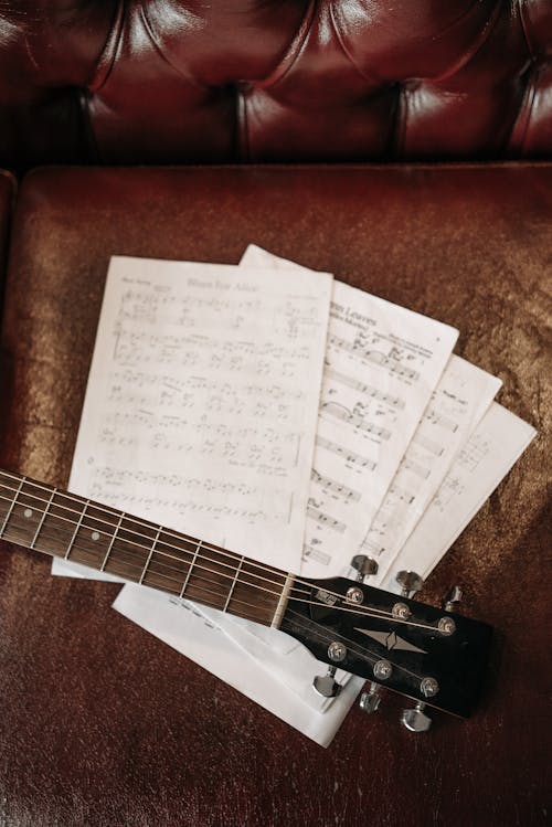 Free Music Sheets on a Leather Sofa  Stock Photo