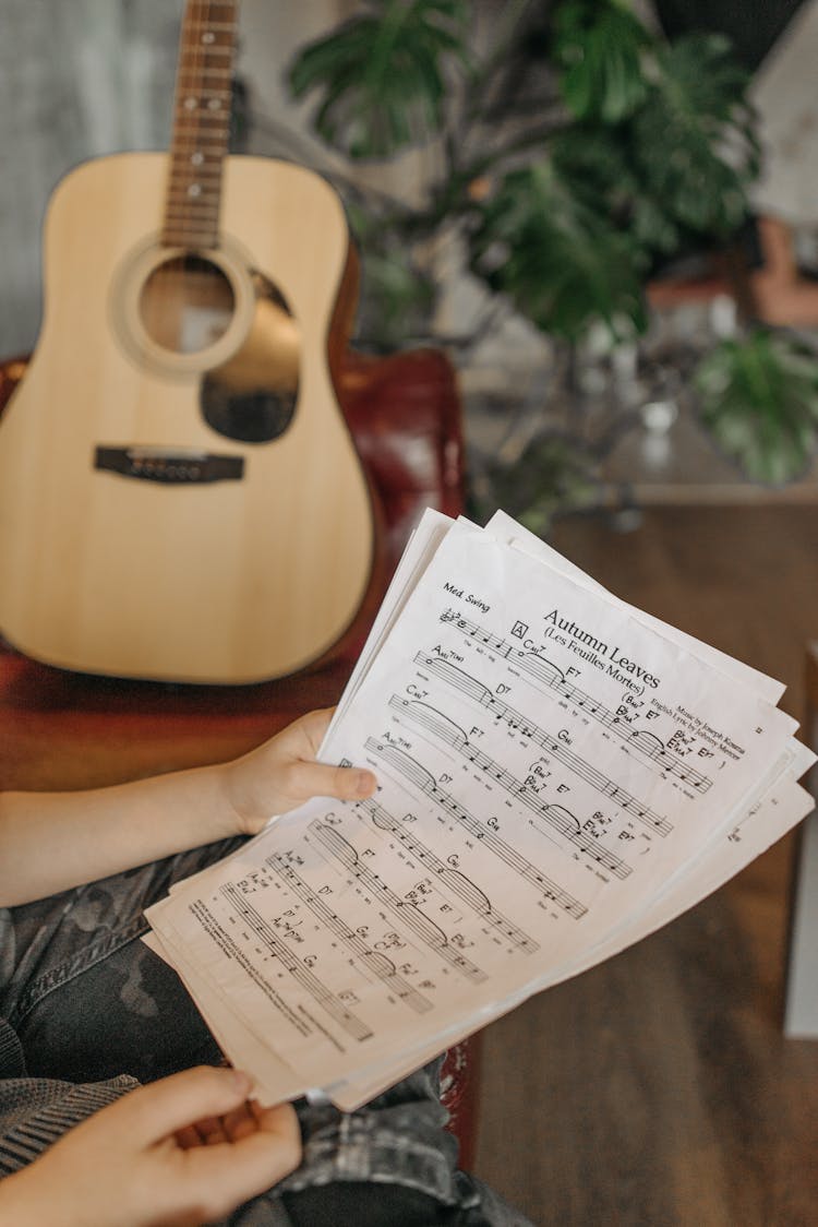 Person Holding Music Sheets