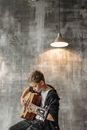 Woman in Black Jacket Playing Brown Acoustic Guitar