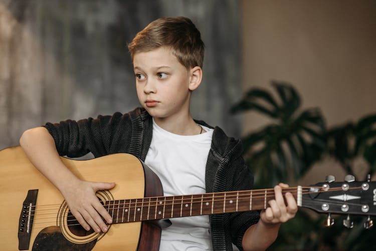 A Young Boy Playing Guitar