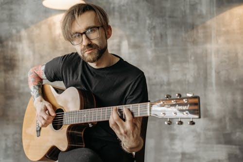 A Man Playing Acoustic Guitar