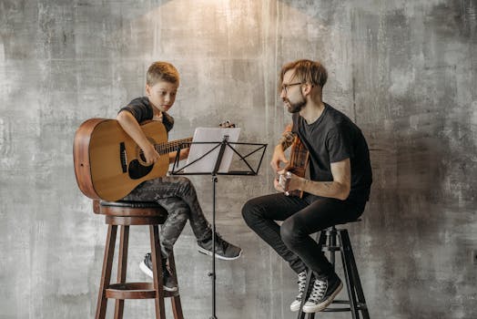 A child learning to play the guitar under the guidance of a teacher in a cozy indoor setting.